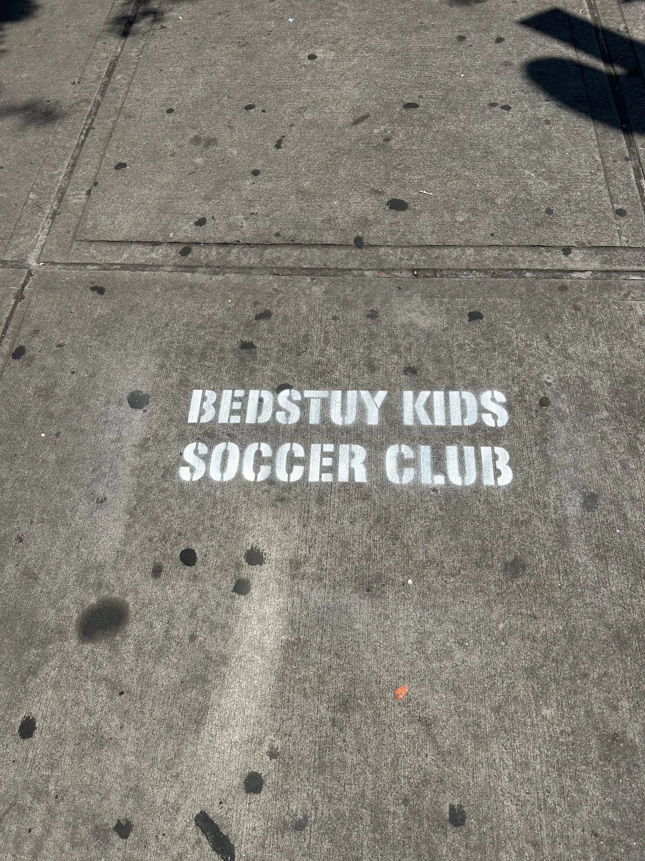 Sidewalk stencil for Bedstuy Kids Soccer Club in Bed-Stuy, Brooklyn NY by Beyond Street Media