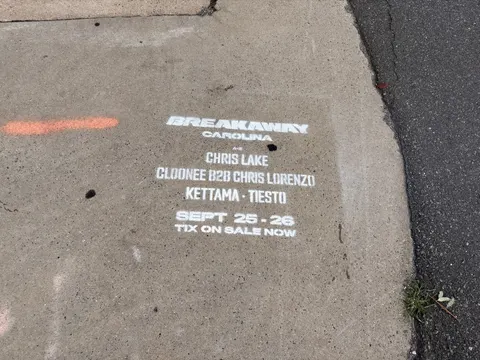 Sidewalk stencil for Breakaway Music Festival painted on the N Brevard St sidewalk, Charlotte NC