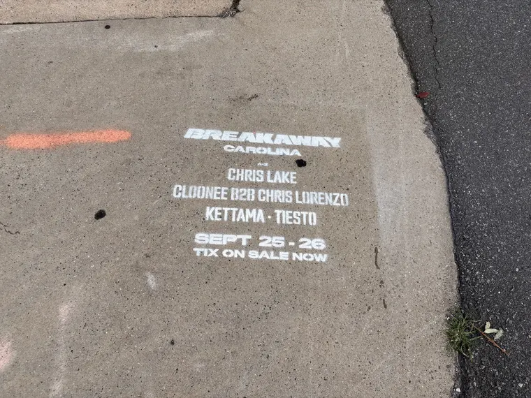 Sidewalk stencil for Breakaway Music Festival painted on the N Brevard St sidewalk, Charlotte NC