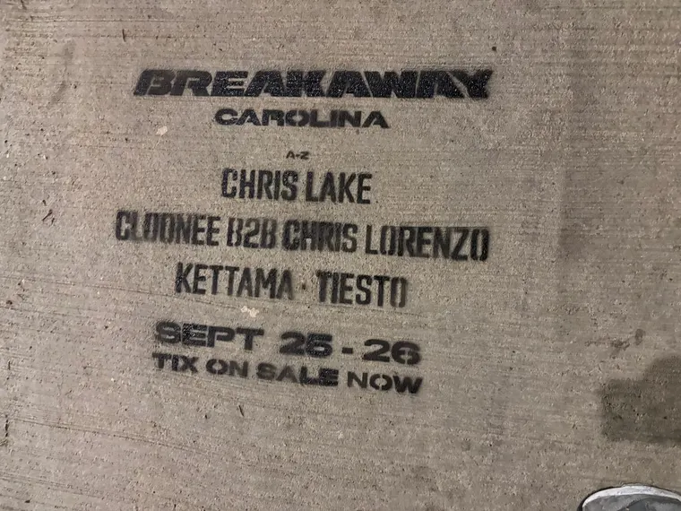 Close-up chalk stencil with the Breakaway Carolina lineup on the stadium block of Mint St, Charlotte