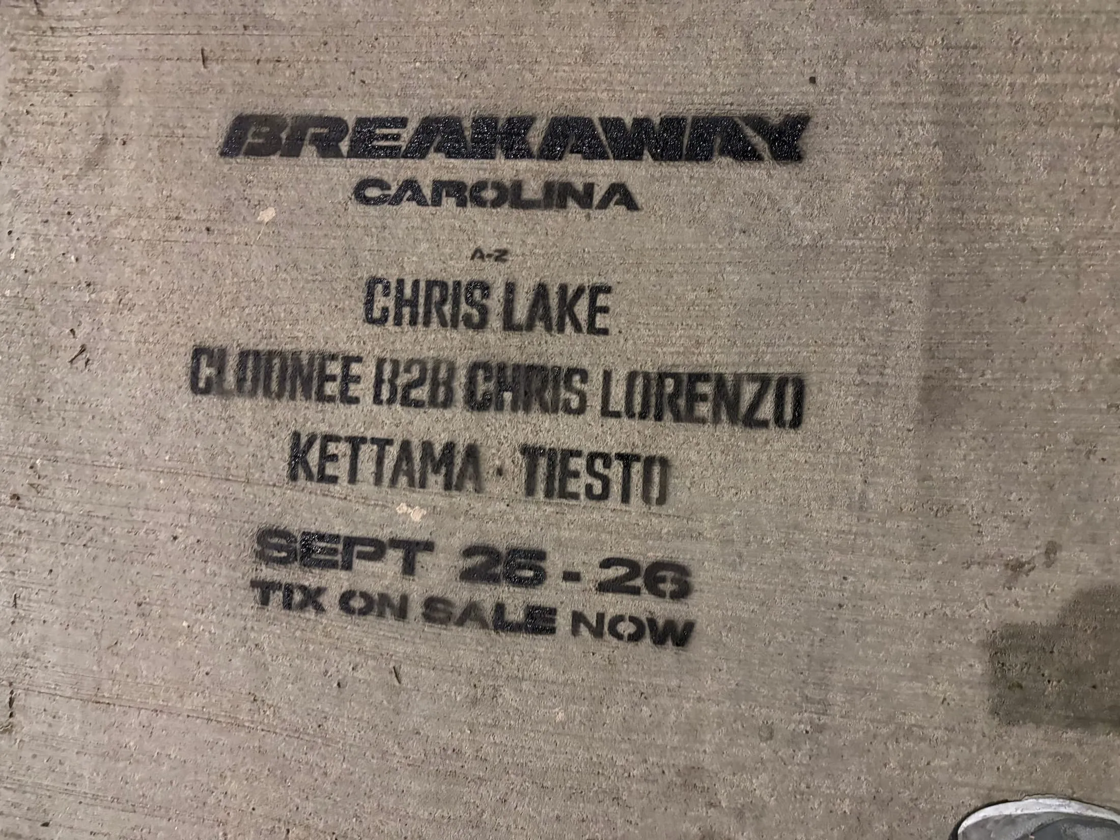 Close-up chalk stencil with the Breakaway Carolina lineup on the stadium block of Mint St, Charlotte