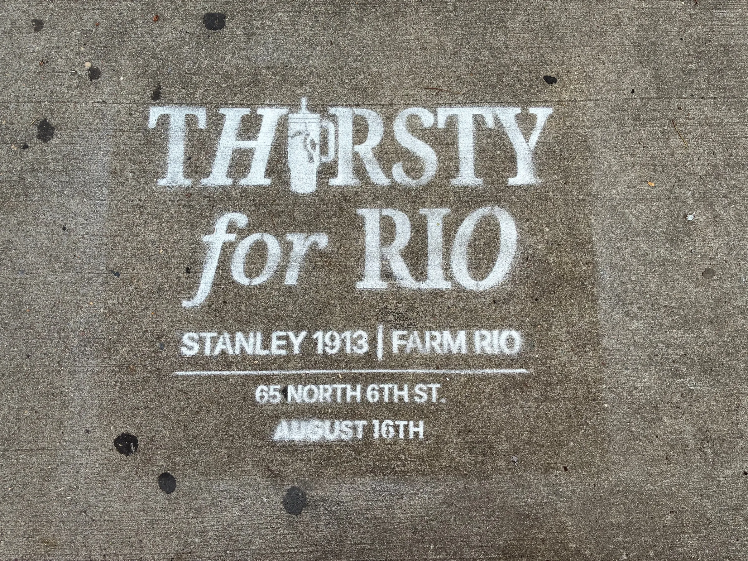 Large head-on Thirsty for Rio stencil with the Stanley 1913 and Farm Rio lockup beneath.