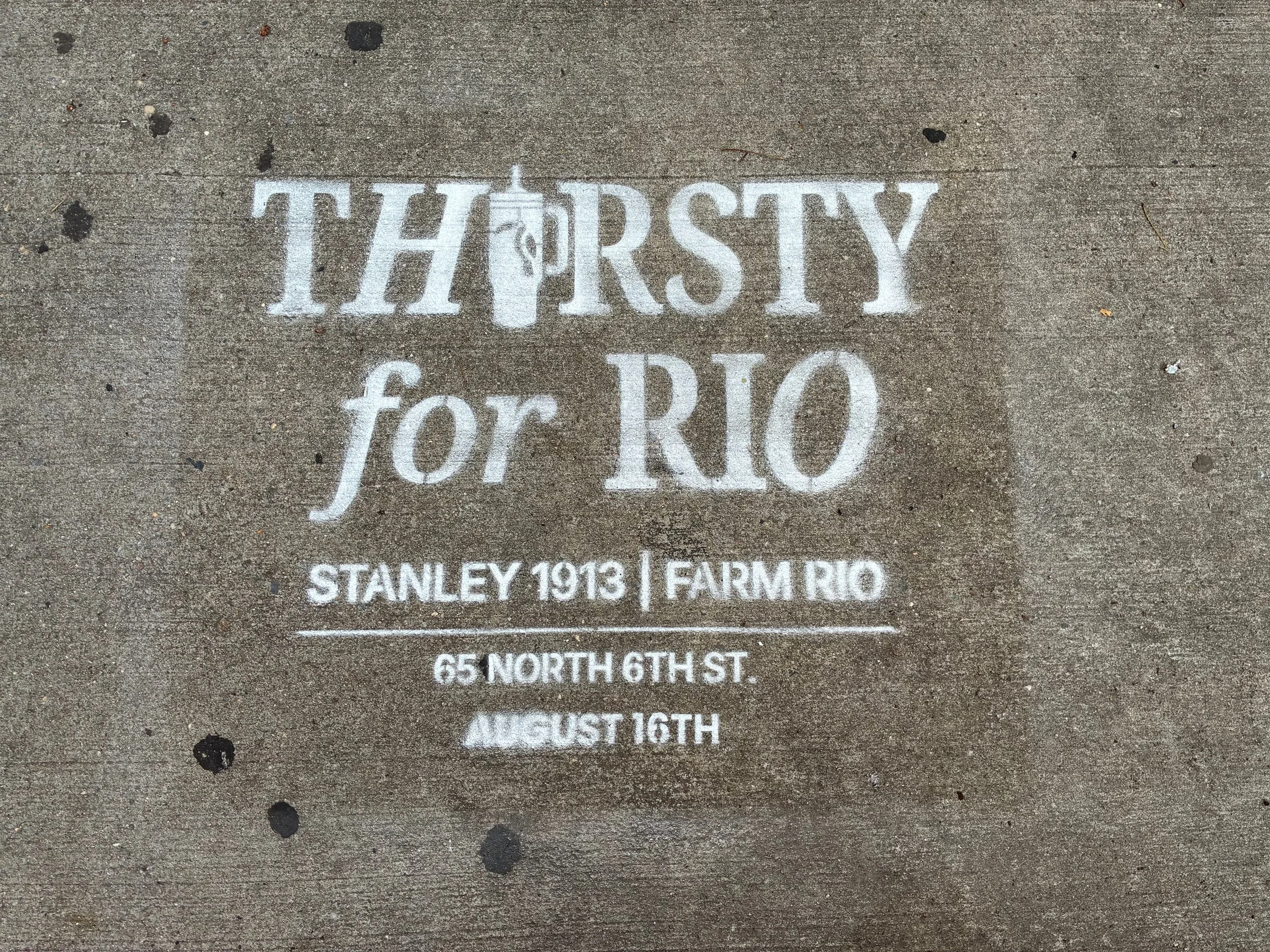 Large head-on Thirsty for Rio stencil with the Stanley 1913 and Farm Rio lockup beneath.