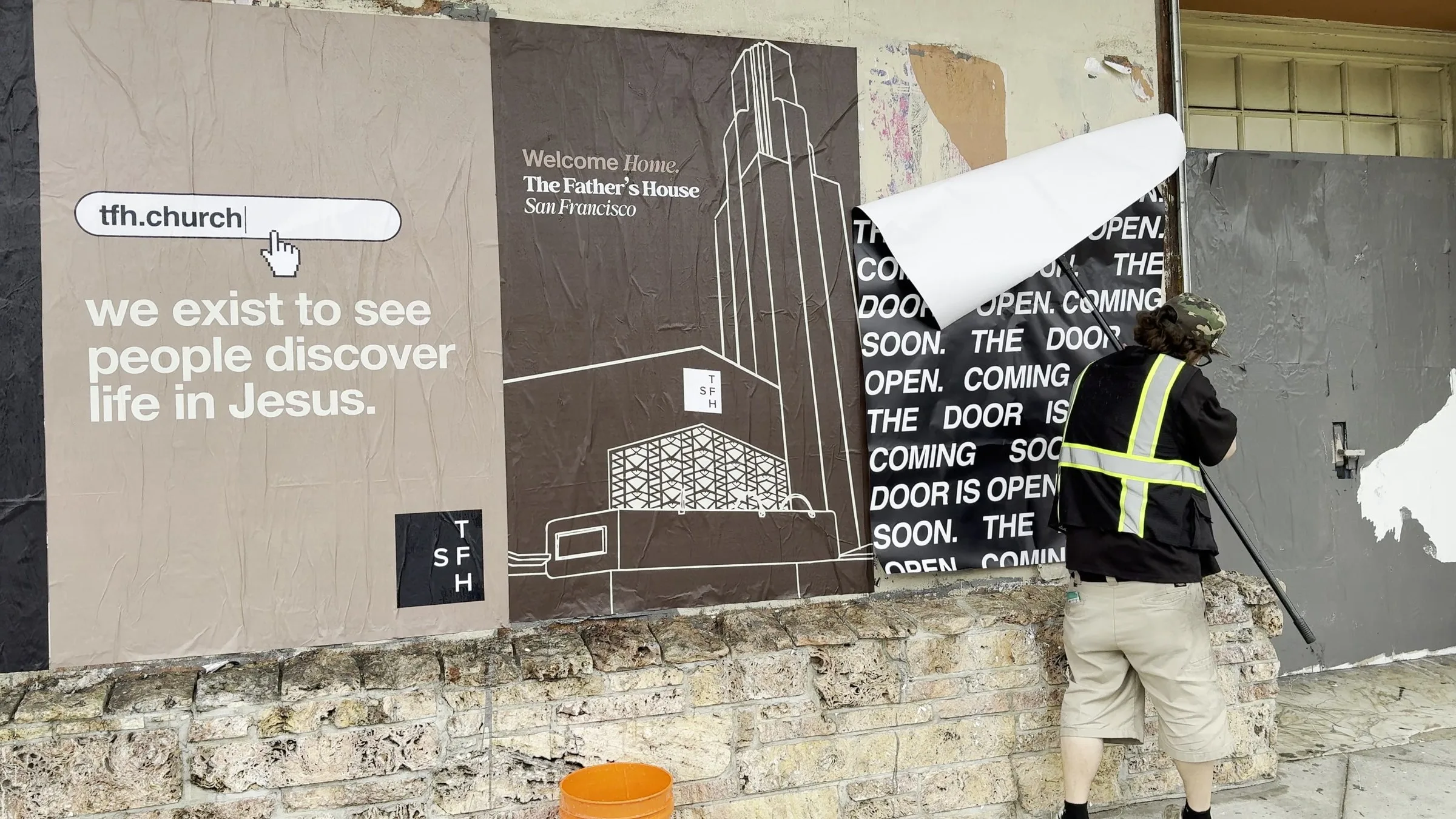 Jumbo custom-branded posters for The Father's House SF covering a street-level wall on Ocean Avenue in San Francisco, CA by Beyond Street Media