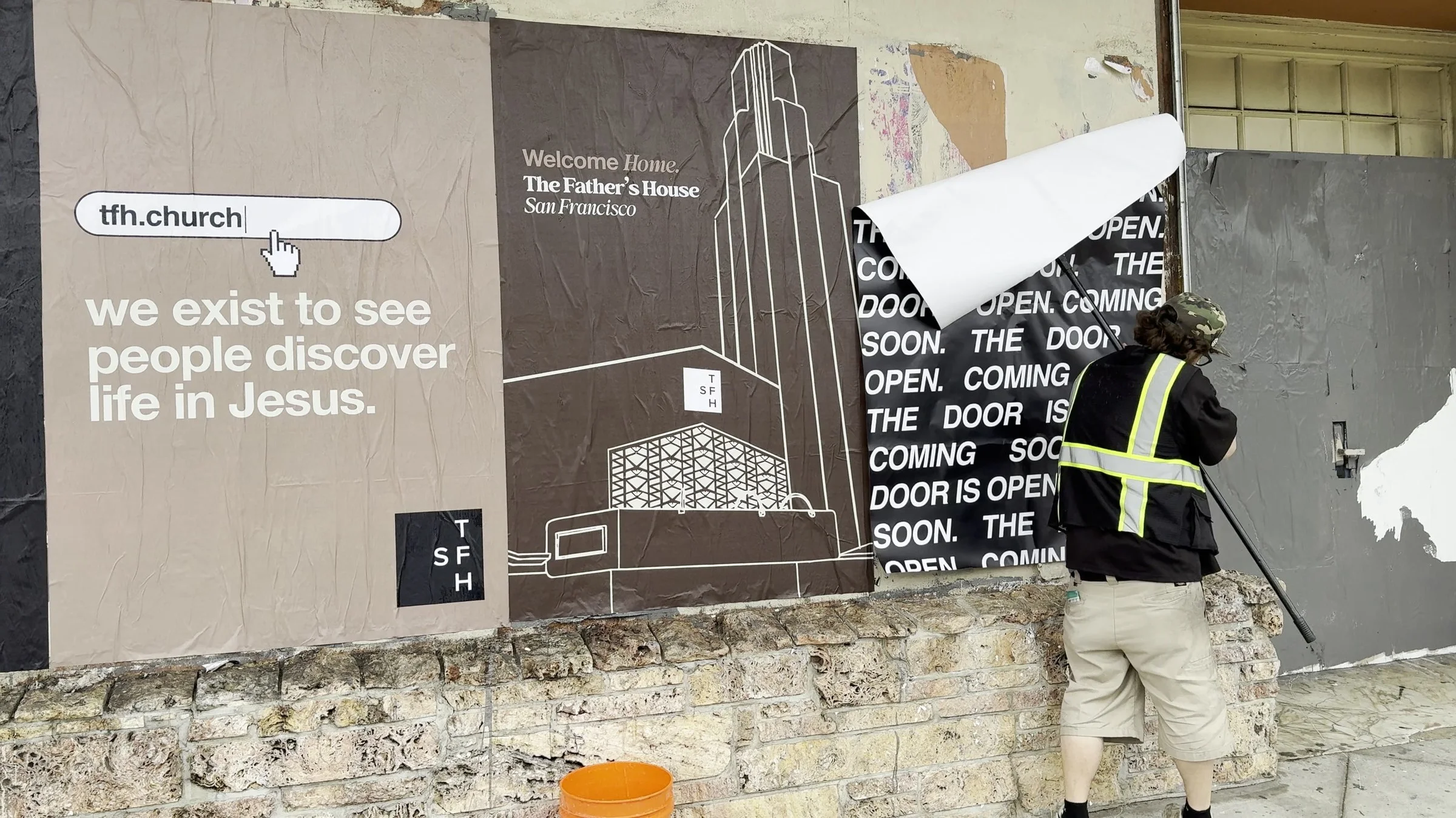 Jumbo custom-branded posters for The Father's House SF covering a street-level wall on Ocean Avenue in San Francisco, CA by Beyond Street Media
