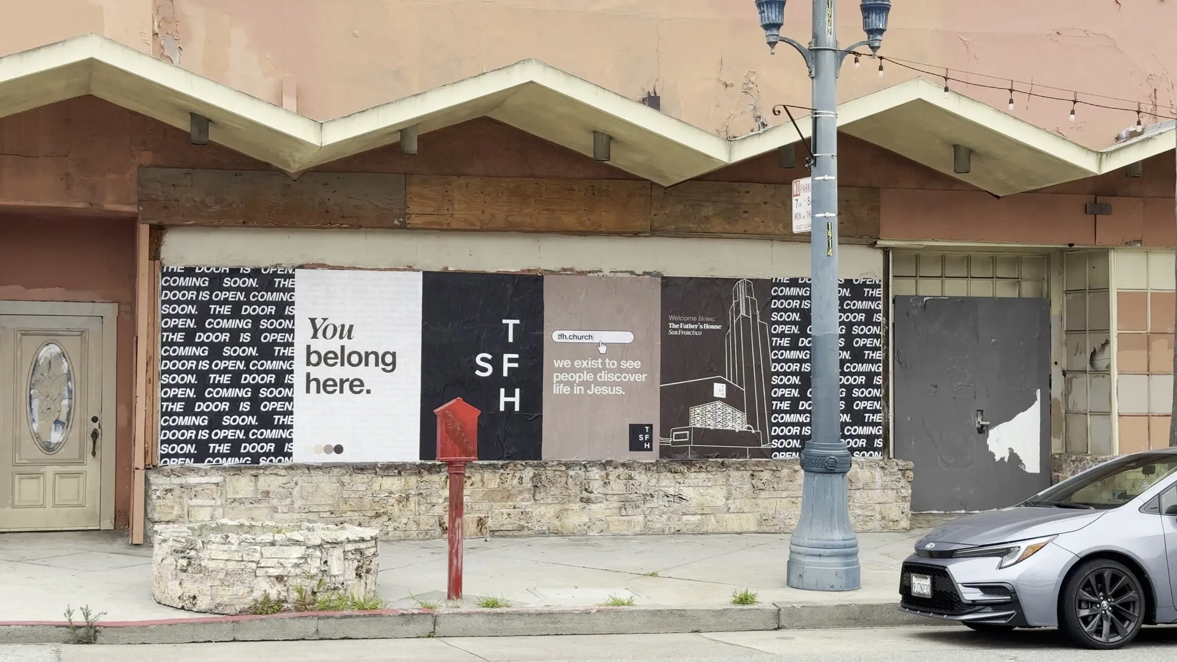 The Father's House SF street-level frontage on Ocean Avenue after the custom poster install by Beyond Street Media.