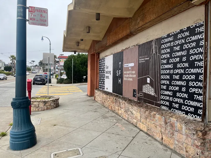 Jumbo custom-branded posters for The Father's House SF covering a street-level wall on Ocean Avenue in San Francisco, CA by Beyond Street Media