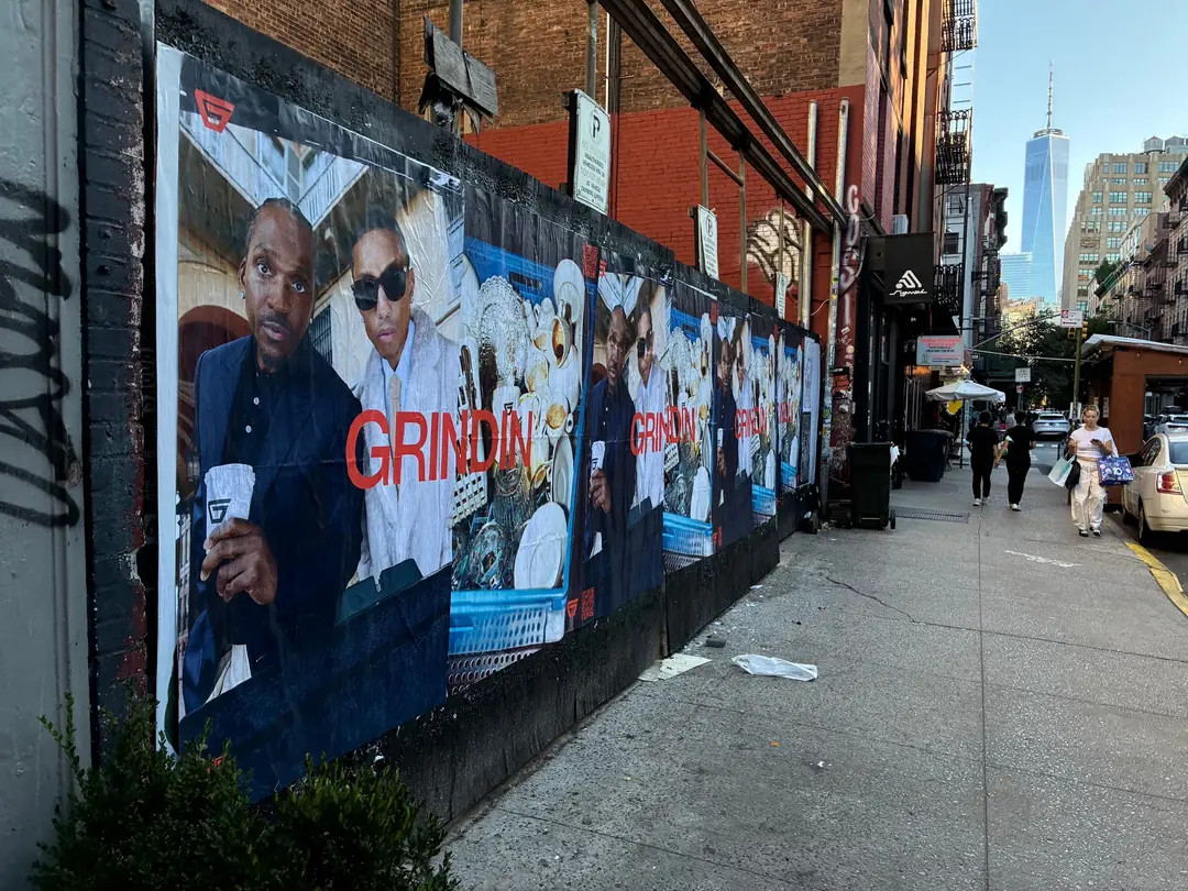 Grindin jumbo wheatpaste poster on a construction hoarding in New York City, installed by Beyond Street Media (photo 4 of 337).