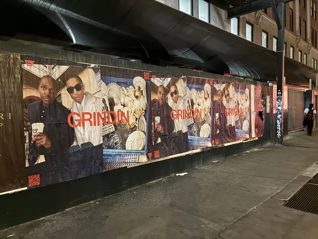 Grindin jumbo wheatpaste poster on a construction hoarding in New York City, installed by Beyond Street Media