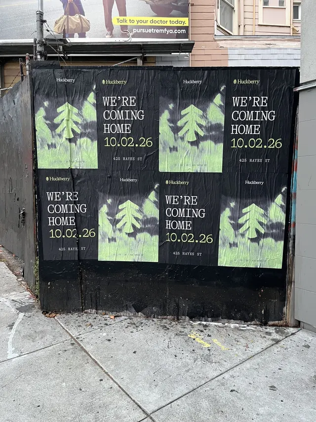 Huckberry wheatpaste posters in a four-by-two block on a black fence on Market Street near Octavia, on the Mission side, close up