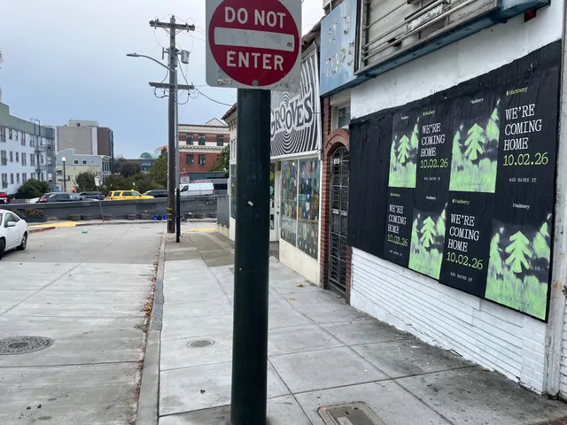 Huckberry wheatpaste posters on a white clapboard wall at Octavia and Market, beside the Grooves record shop sign