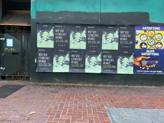 Huckberry wheatpaste posters twelve sheets on a teal and black wall on Market Street between Gough and Octavia, beside a gated doorway