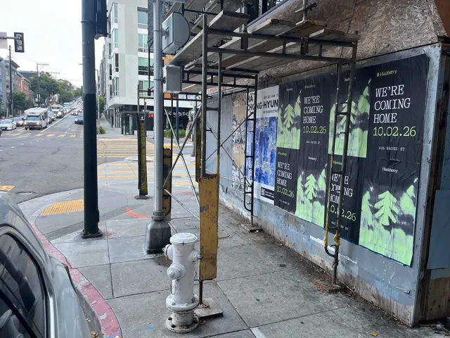 Huckberry wheatpaste posters on boards behind scaffolding at Oak Street and Octavia Boulevard, Hayes Valley