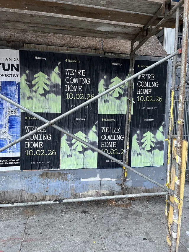Huckberry wheatpaste posters on boards behind scaffolding poles at Oak Street and Octavia Boulevard, Hayes Valley, close up