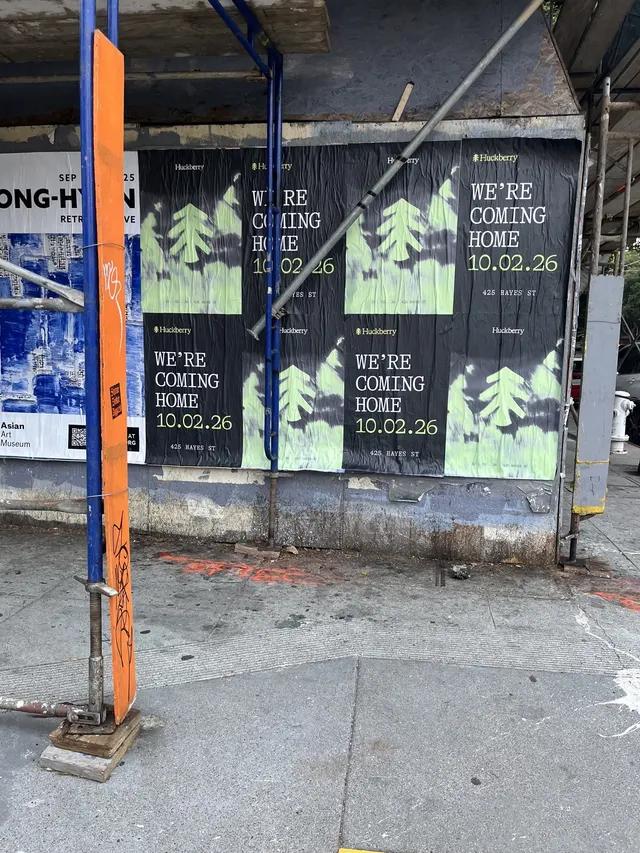 Huckberry wheatpaste posters behind a scaffolding brace at Oak Street and Octavia Boulevard, Hayes Valley, close up