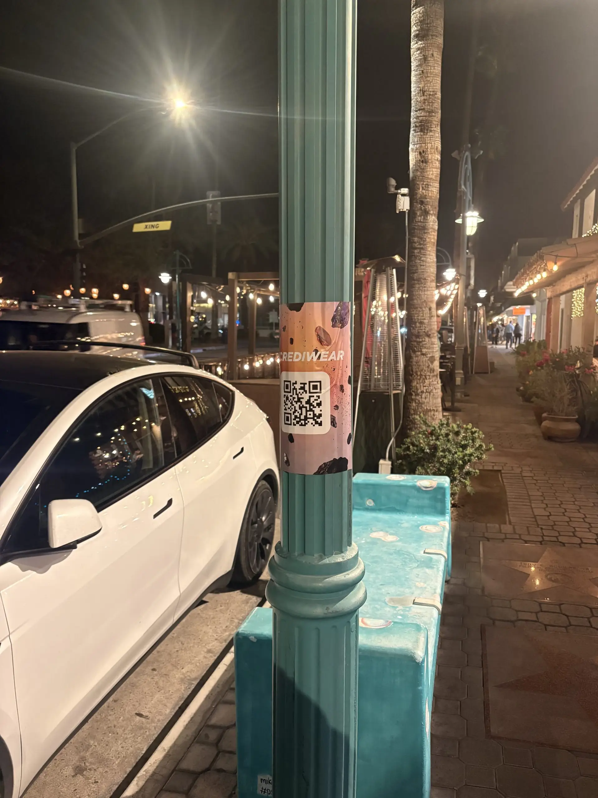 Incrediwear pull-tab QR pole sticker in the Coachella Valley during the BNP Paribas Open, Beyond Street Media install, by Beyond Street Media