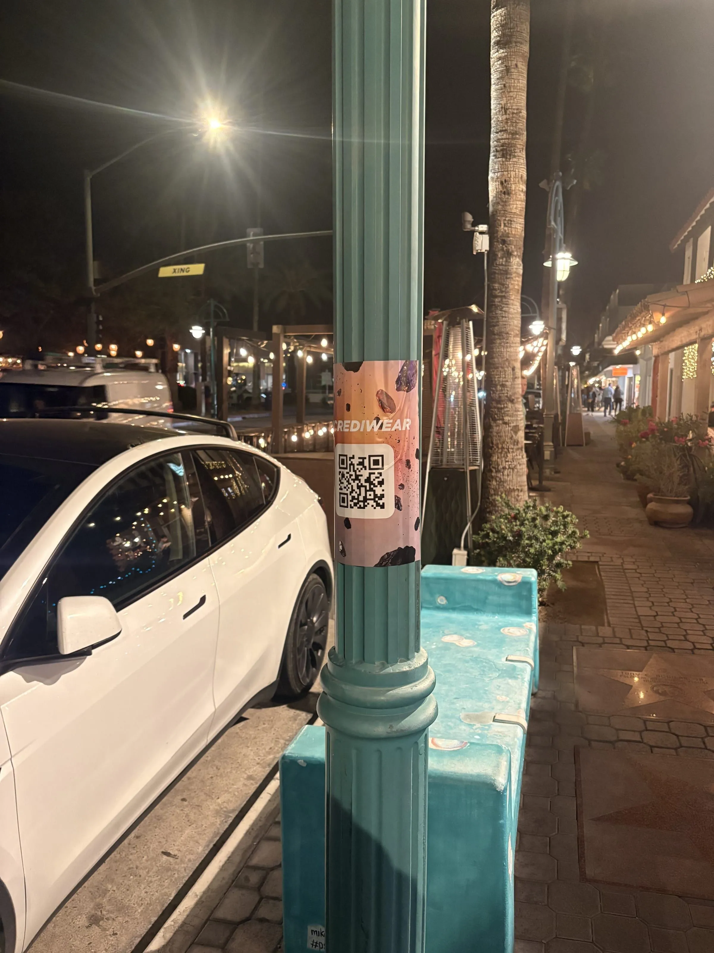 Incrediwear pull-tab QR pole sticker in the Coachella Valley during the BNP Paribas Open, The Complete Guide to Guerrilla Marketing, by Beyond Street Media