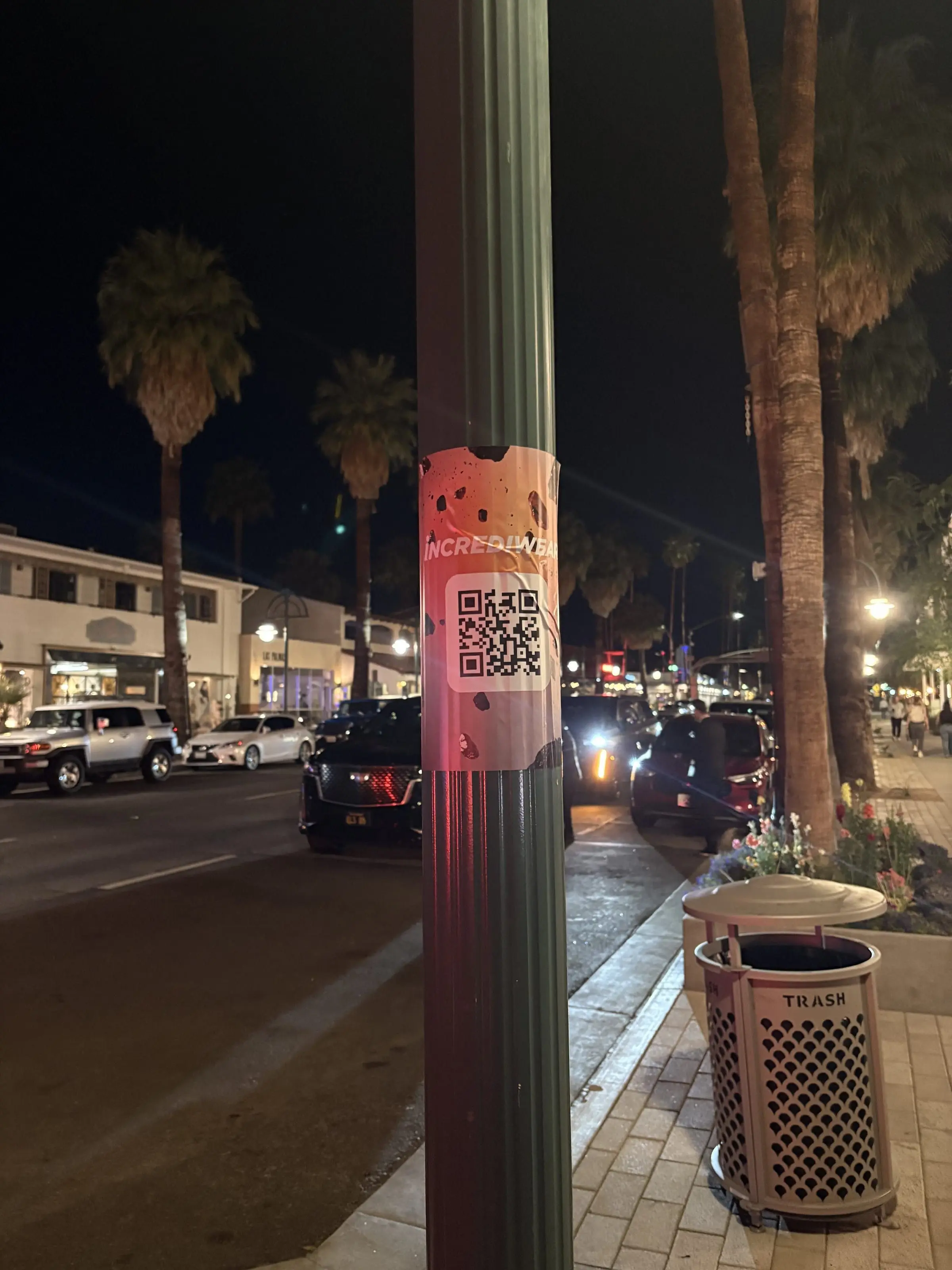 Incrediwear pull-tab QR pole sticker in the Coachella Valley during the BNP Paribas Open, documented street install, by Beyond Street Media