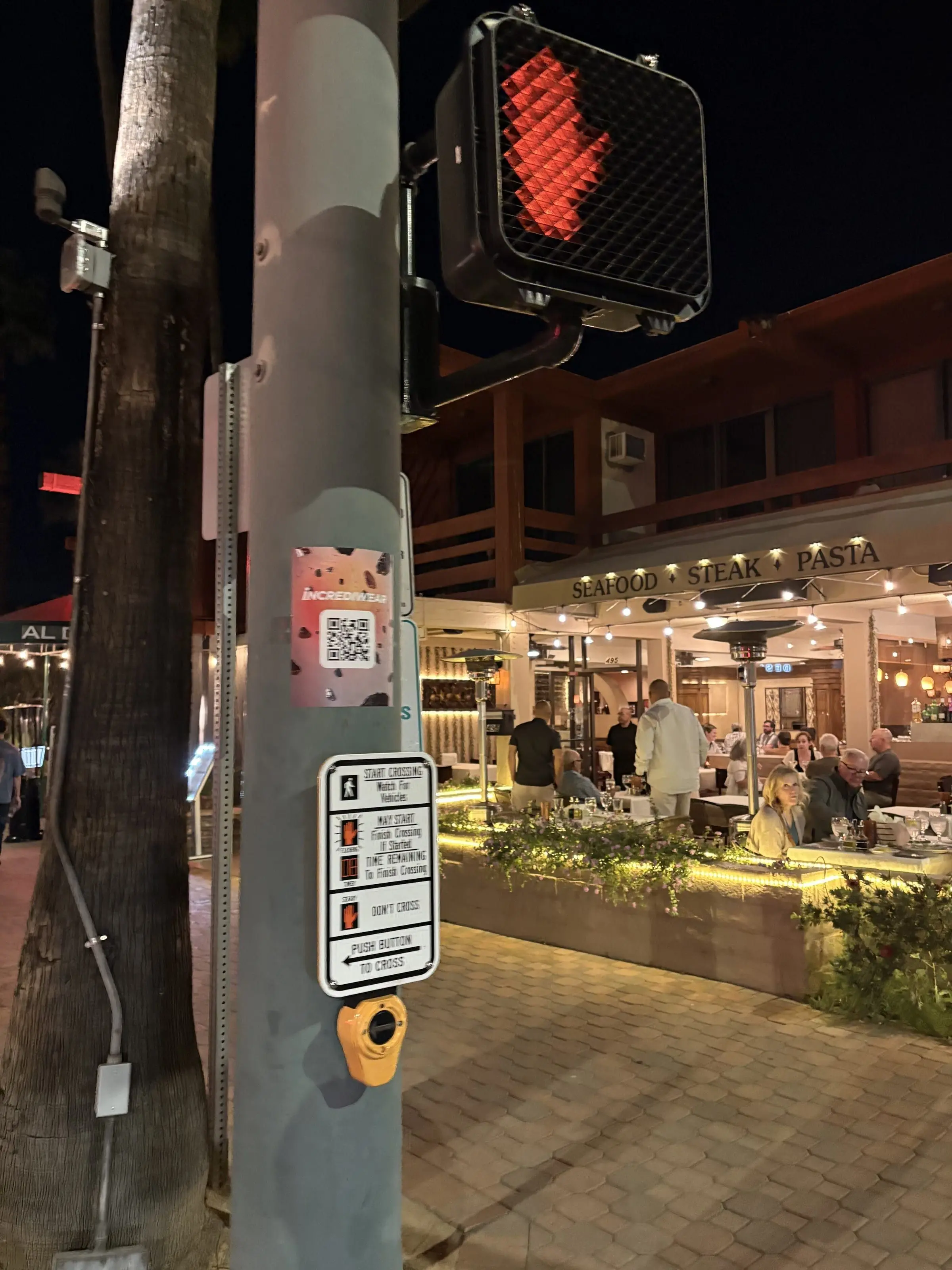 Incrediwear pull-tab QR pole sticker in the Coachella Valley during the BNP Paribas Open, documented street install, by Beyond Street Media