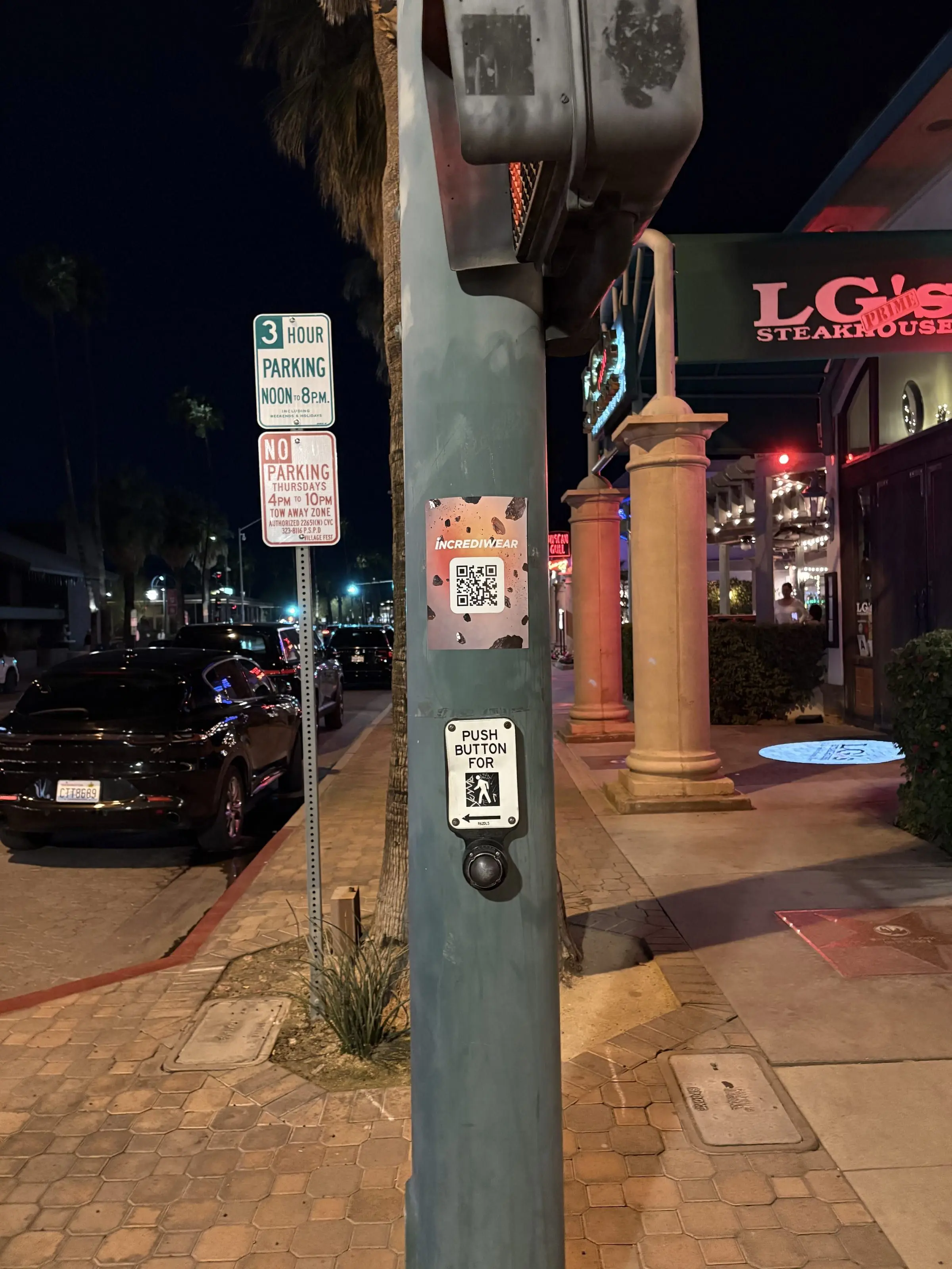 Incrediwear pull-tab QR pole sticker in the Coachella Valley during the BNP Paribas Open, documented street install, by Beyond Street Media