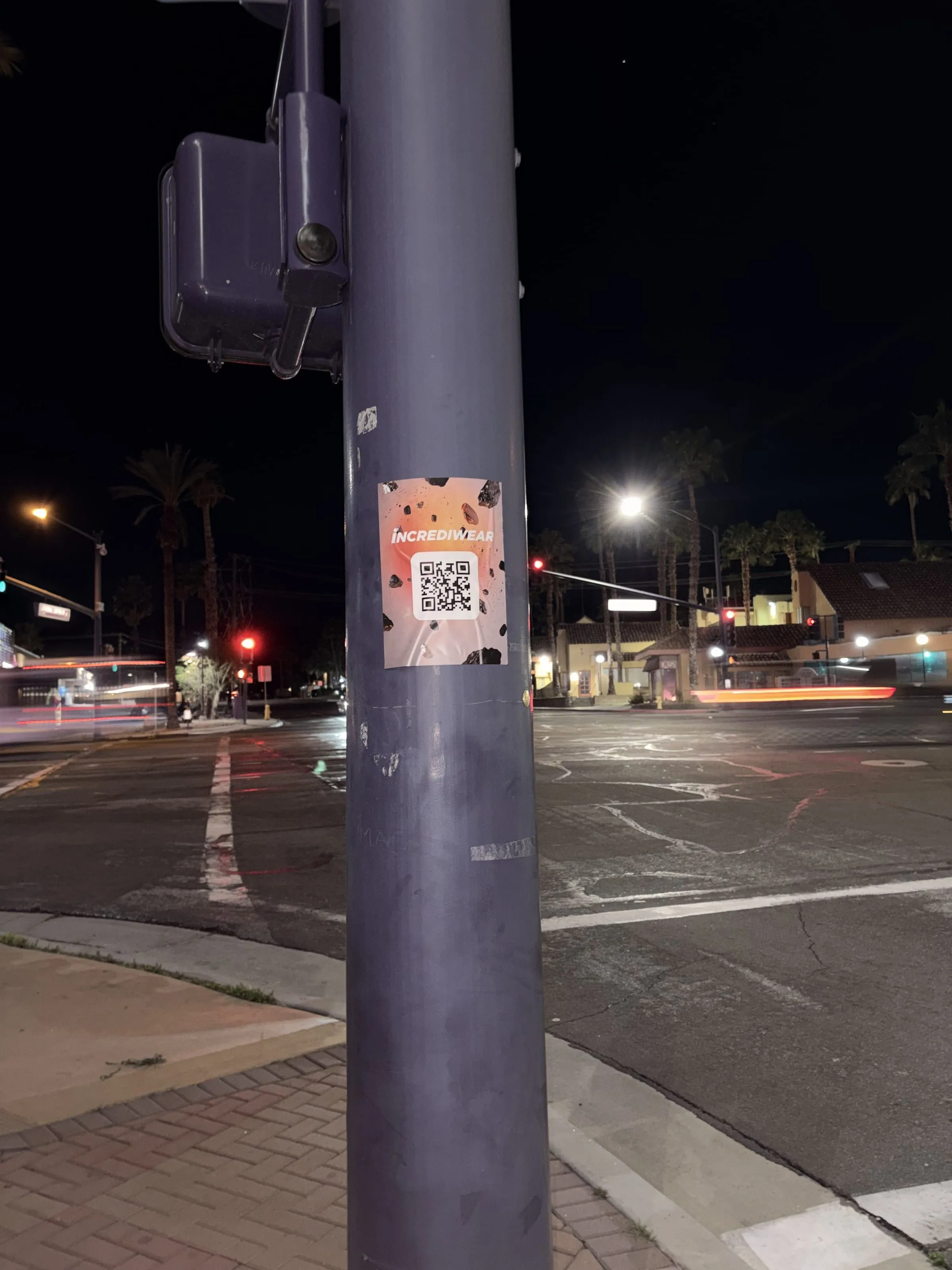 Incrediwear pull-tab QR pole sticker in the Coachella Valley during the BNP Paribas Open, documented street install, by Beyond Street Media