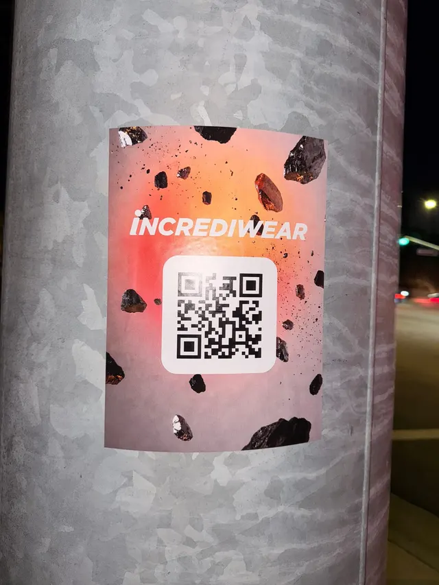 Incrediwear pull-tab QR pole sticker in the Coachella Valley during the BNP Paribas Open, documented street install, by Beyond Street Media (photo 12 of 38).