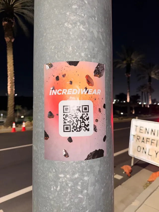 Incrediwear pull-tab QR pole sticker in the Coachella Valley during the BNP Paribas Open, documented street install, by Beyond Street Media (photo 16 of 38).