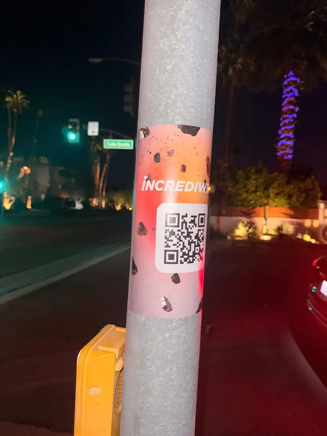 Incrediwear pull-tab QR pole sticker in the Coachella Valley during the BNP Paribas Open, documented street install, by Beyond Street Media (photo 26 of 38).