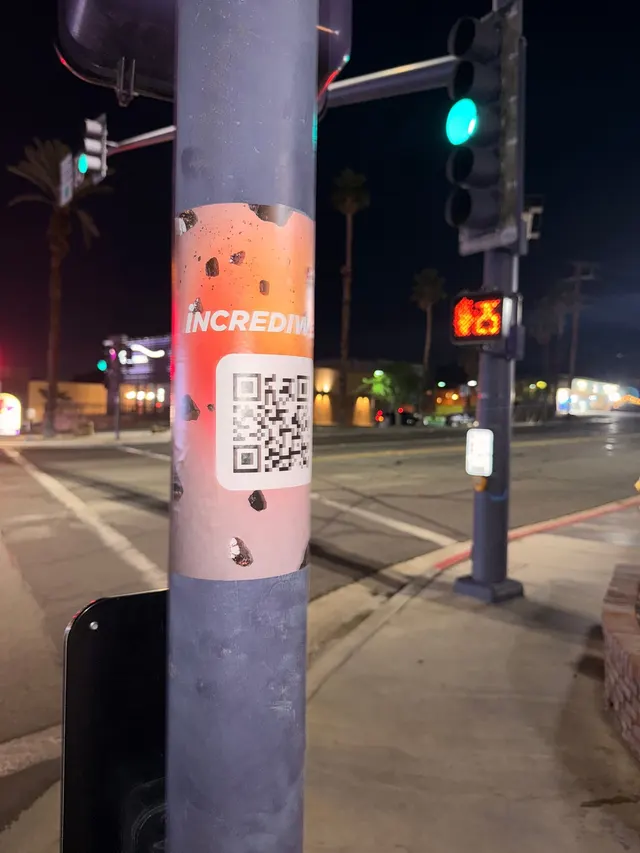 Incrediwear pull-tab QR pole sticker in the Coachella Valley during the BNP Paribas Open, documented street install, by Beyond Street Media (photo 27 of 38).