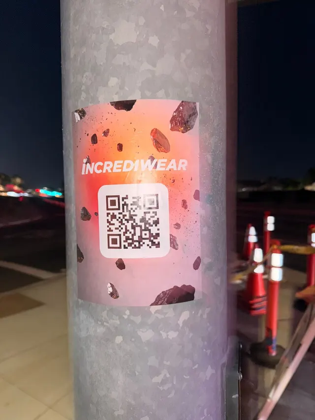 Incrediwear pull-tab QR pole sticker in the Coachella Valley during the BNP Paribas Open, documented street install, by Beyond Street Media (photo 29 of 38).