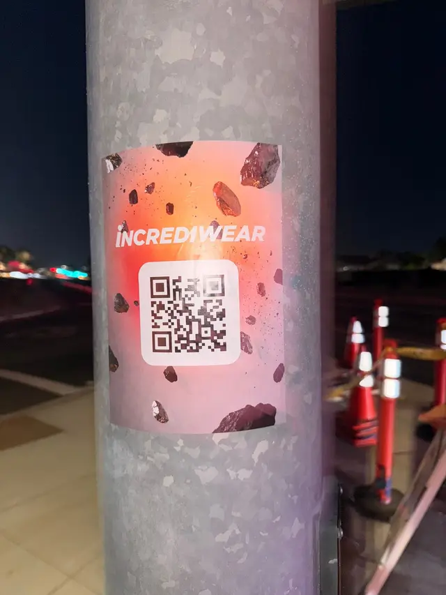 Incrediwear pull-tab QR pole sticker in the Coachella Valley during the BNP Paribas Open, documented street install, by Beyond Street Media (photo 29 of 38).