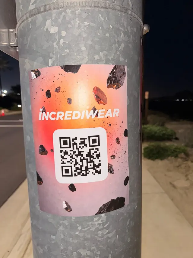 Incrediwear pull-tab QR pole sticker in the Coachella Valley during the BNP Paribas Open, documented street install, by Beyond Street Media (photo 30 of 38).