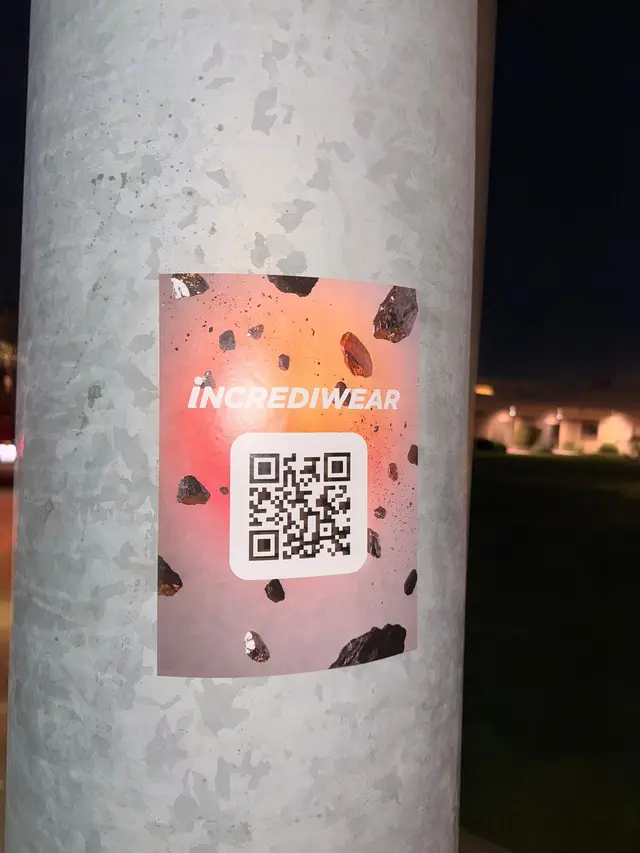 Incrediwear pull-tab QR pole sticker in the Coachella Valley during the BNP Paribas Open, documented street install, by Beyond Street Media (photo 32 of 38).