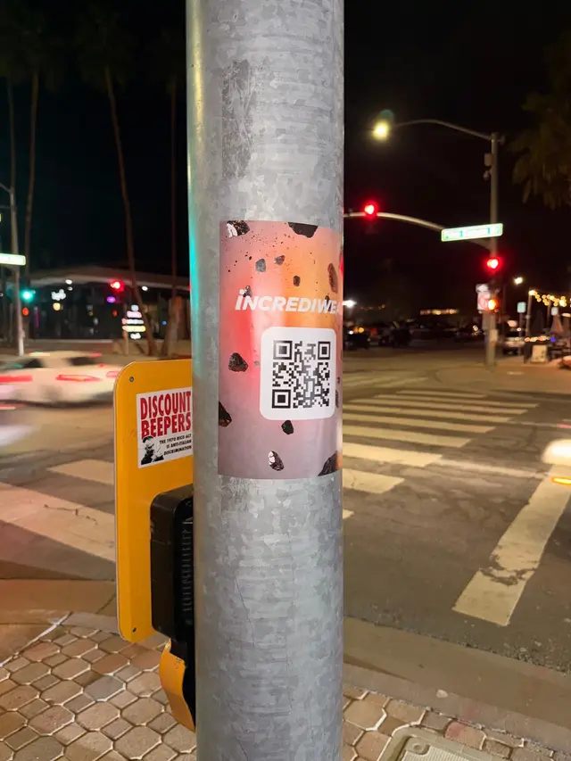 Incrediwear pull-tab QR pole sticker in the Coachella Valley during the BNP Paribas Open, documented street install, by Beyond Street Media (photo 35 of 38).