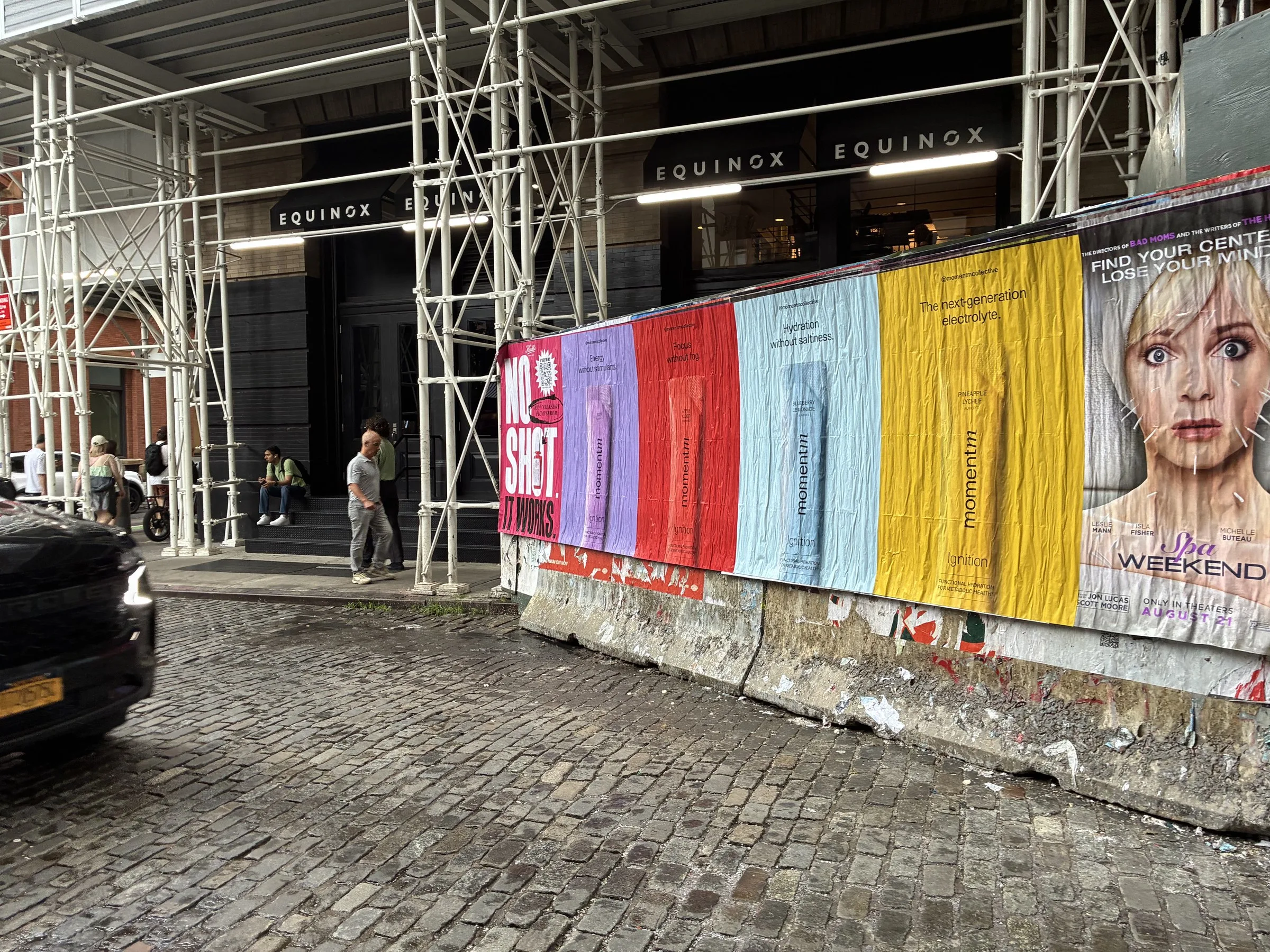 Momentm jumbo poster set wrapping a scaffolded SoHo corner in New York by Beyond Street Media.