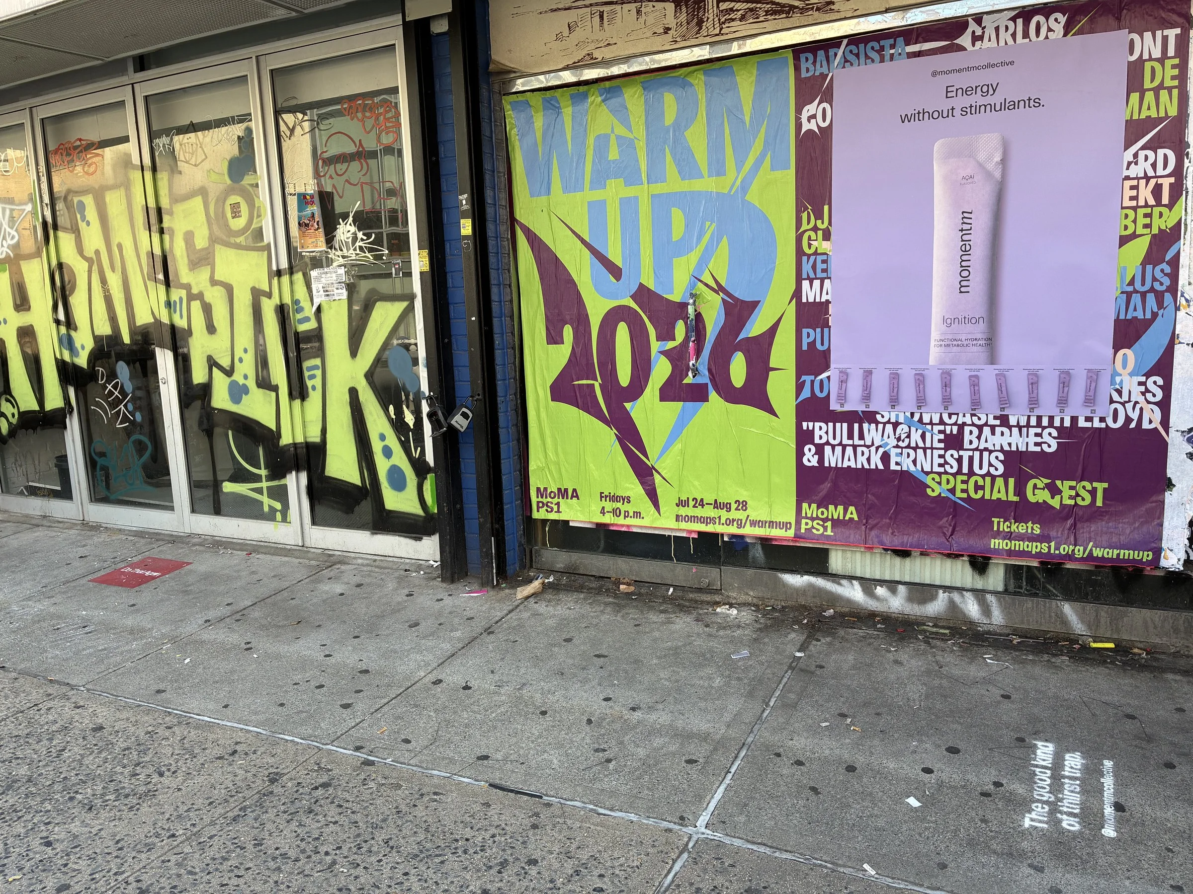 Momentm takeaway poster with product sample stick packs installed on a New York wall by Beyond Street Media.