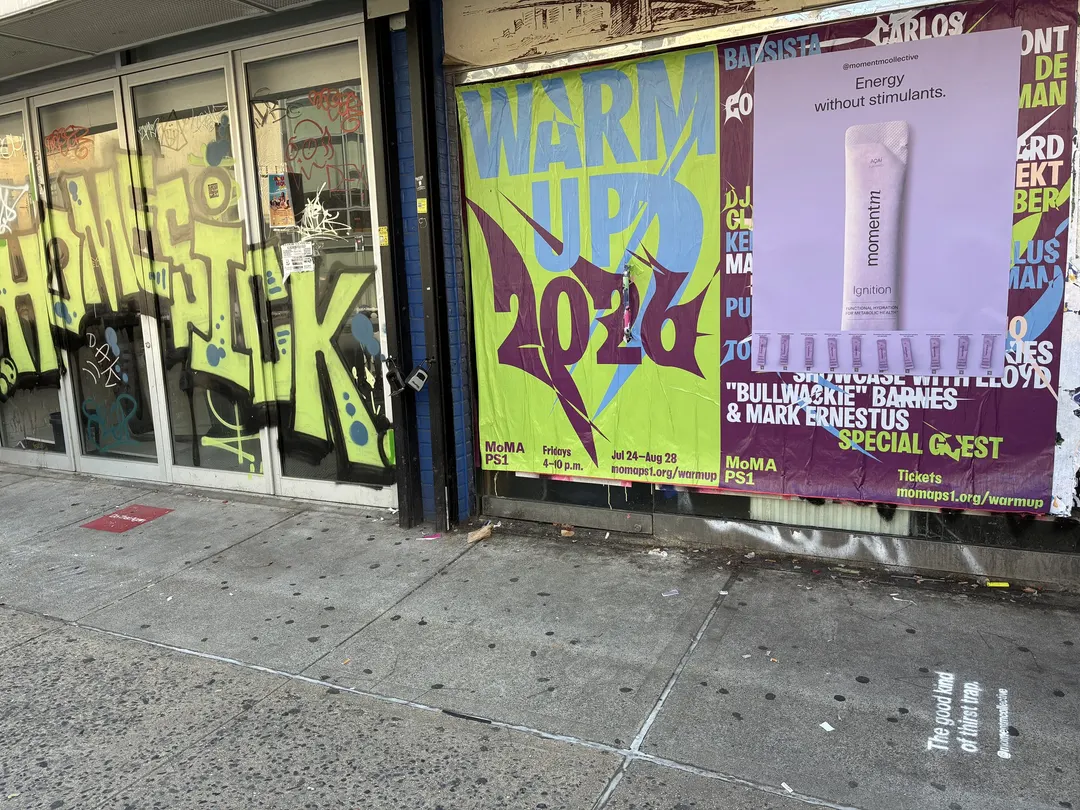 Momentm takeaway poster with product sample stick packs installed on a New York wall by Beyond Street Media.