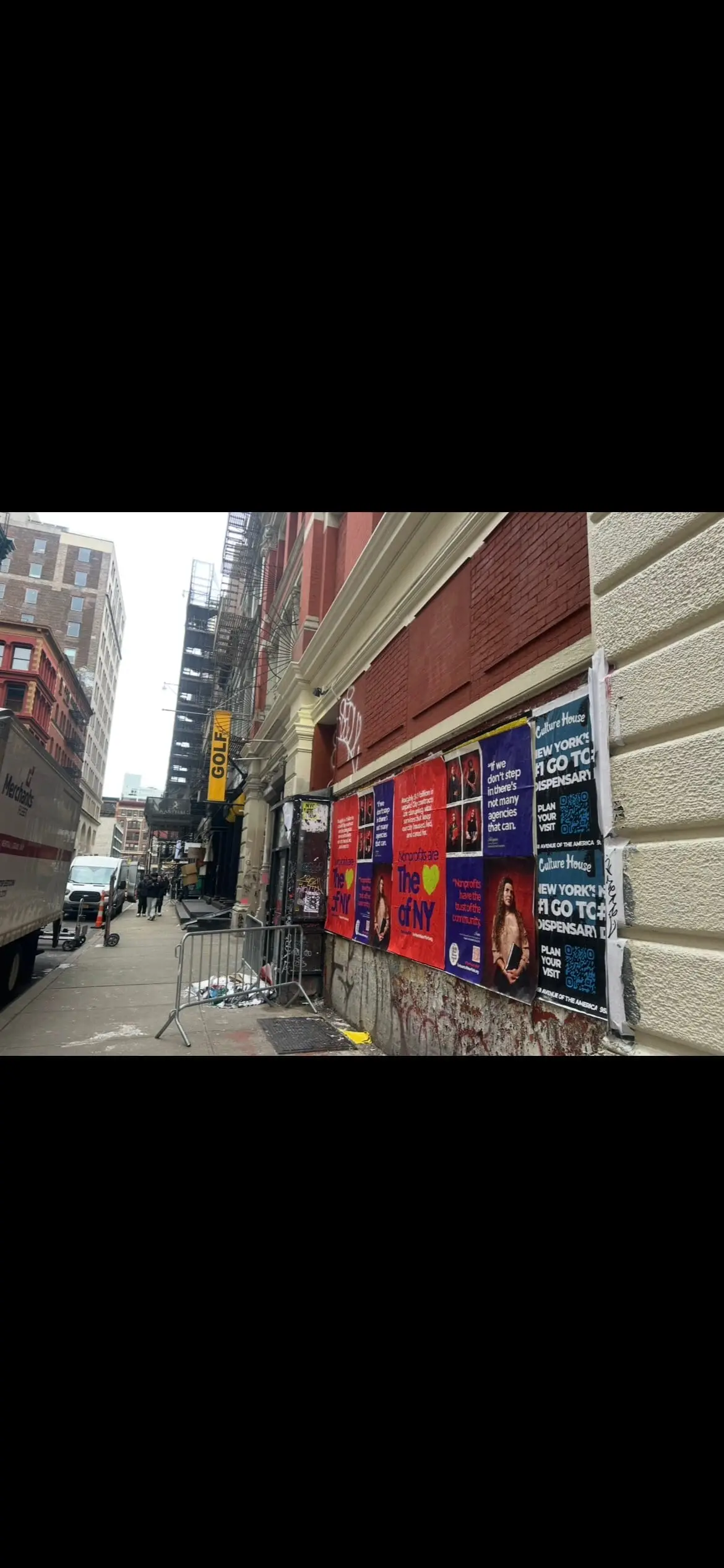 Wheatpaste poster install for 'Nonprofits are The Heart of NY' advocacy campaign on New York City, NY in New York City, New York City, red and blue posters about unpaid City contracts by Beyond Street Media