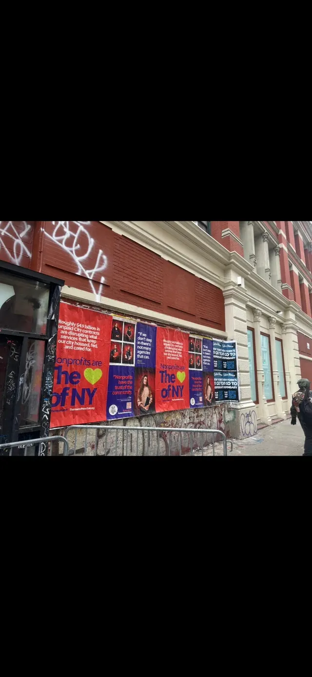 Wheatpaste poster install for 'Nonprofits are The Heart of NY' advocacy campaign on New York City, NY in New York City, red and blue posters about unpaid City contracts by Beyond Street Media (photo 3 of 3).