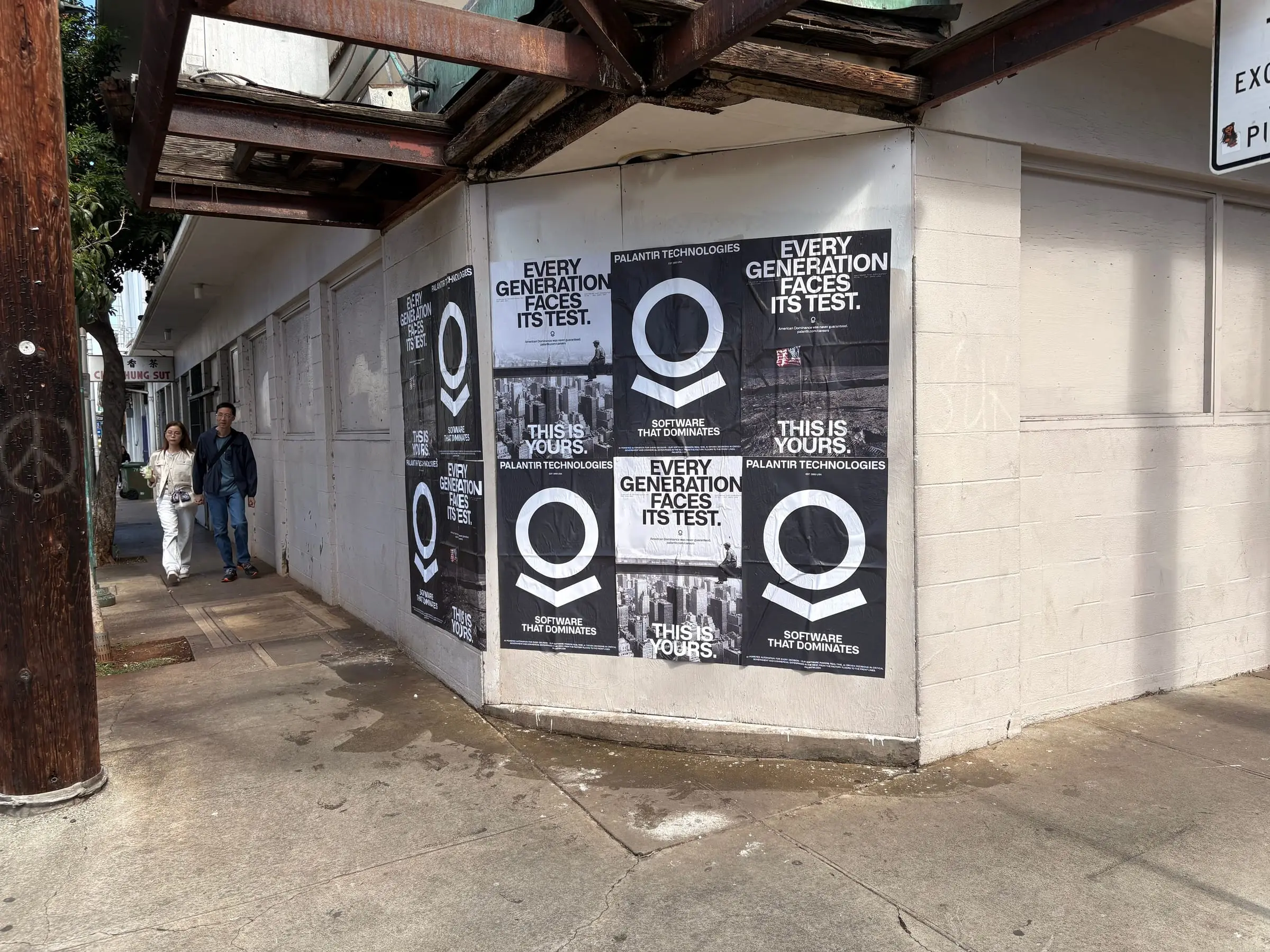 Wheatpaste poster install for Palantir Technologies on Honolulu, HI in Honolulu, HI, black-and-white 'Every Generation Faces Its Test / This Is Yours' paste-up poster install by Beyond Street Media