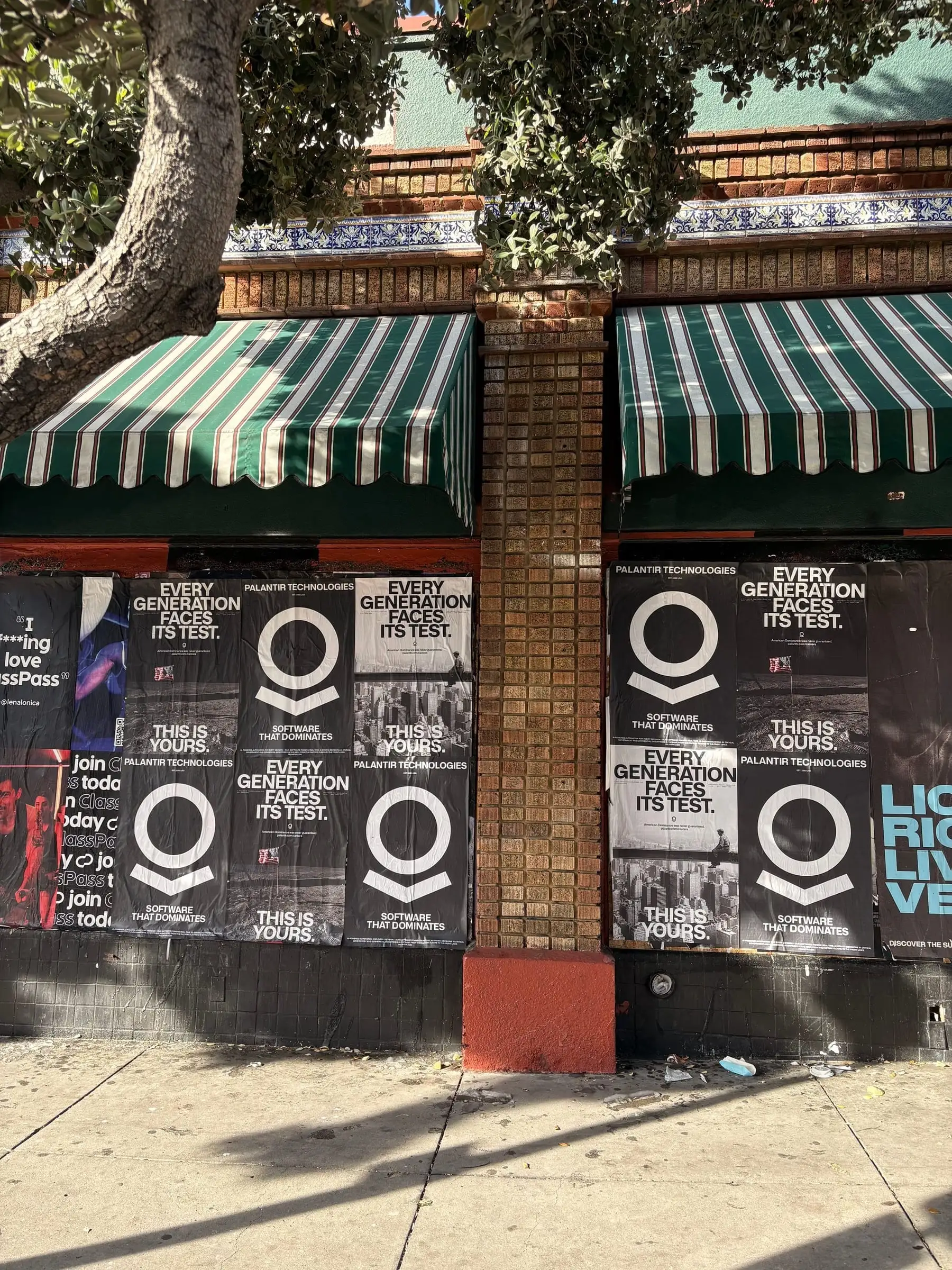 Wheatpaste poster install for Palantir Technologies on San Diego, CA in San Diego, CA, black-and-white 'Every Generation Faces Its Test / This Is Yours' paste-up poster install by Beyond Street Media