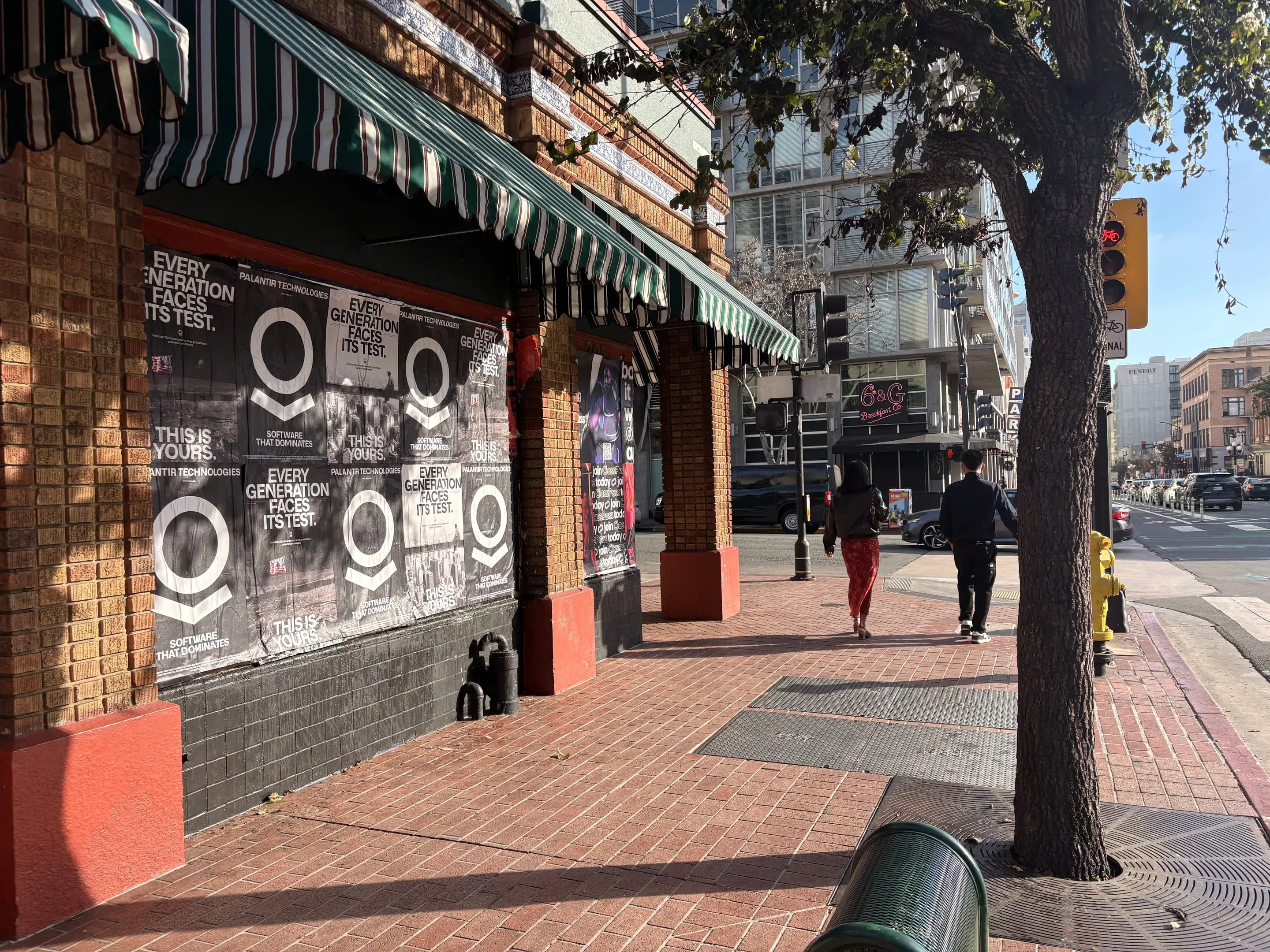 Wheatpaste poster install for Palantir Technologies on San Diego, CA in San Diego, CA, black-and-white 'Every Generation Faces Its Test / This Is Yours' paste-up poster install by Beyond Street Media