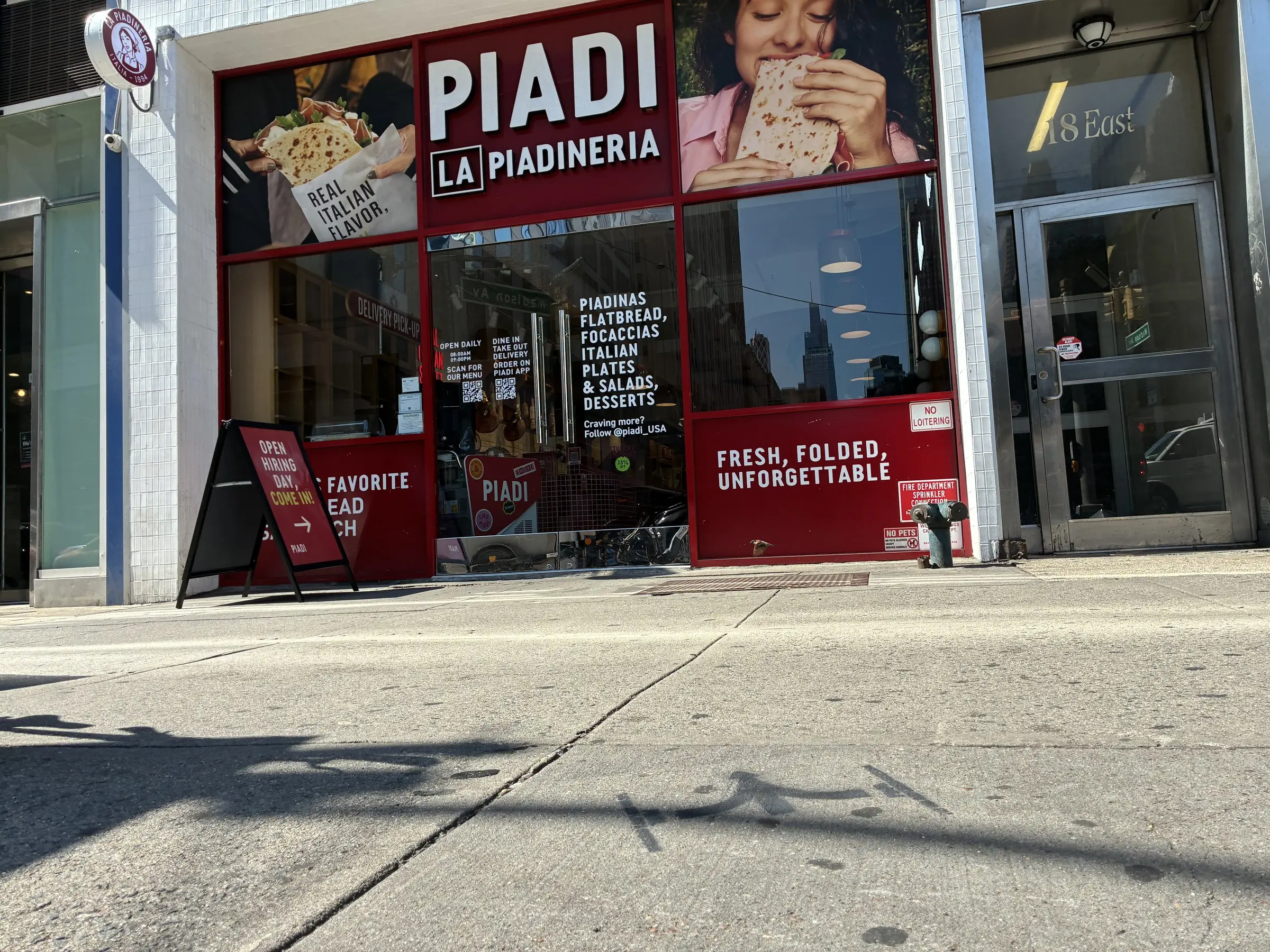 Chalk stencil outside the PIADI storefront on the 23rd St retail corridor.