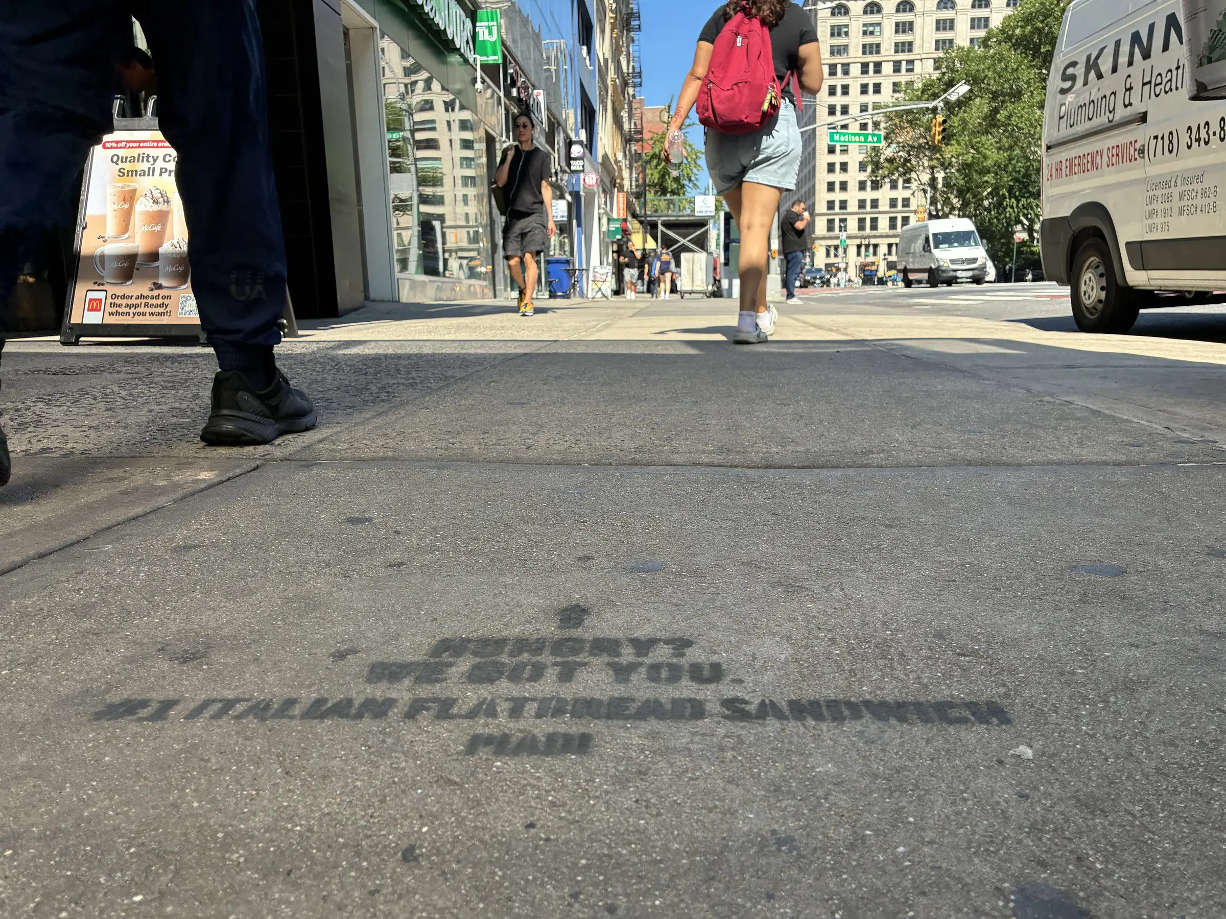 PIADI chalk stencil reading Hungry? We got you, number one Italian flatbread sandwich, on a Manhattan sidewalk.