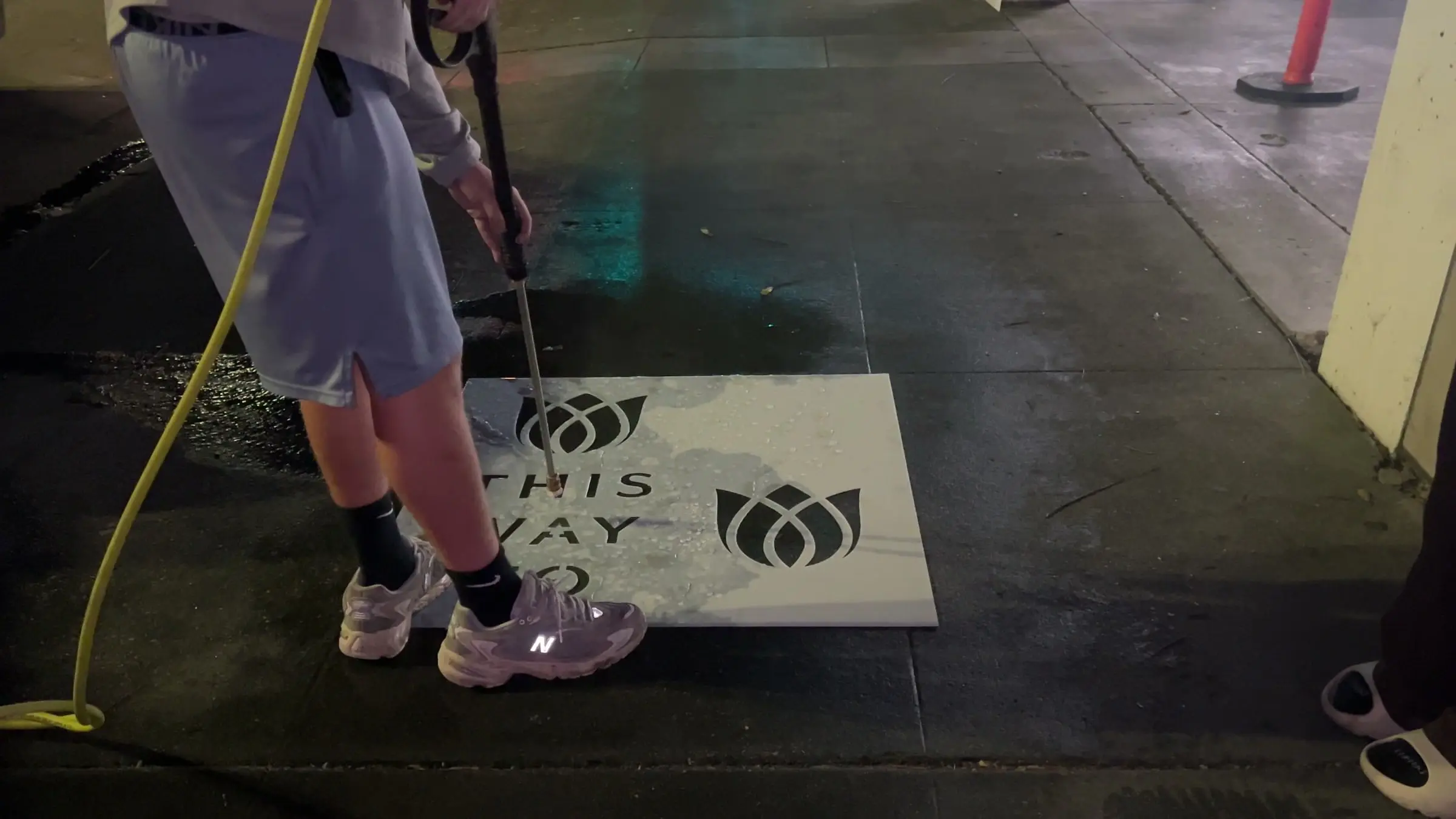 Reverse stencil clean-tag install for Bloomeffects 'Tulip Powered Skincare' on New York City sidewalk in New York City: pressure-washed logo revealed in clean concrete by Beyond Street Media. No paint, no chalk, no ink, only the absence of grime.