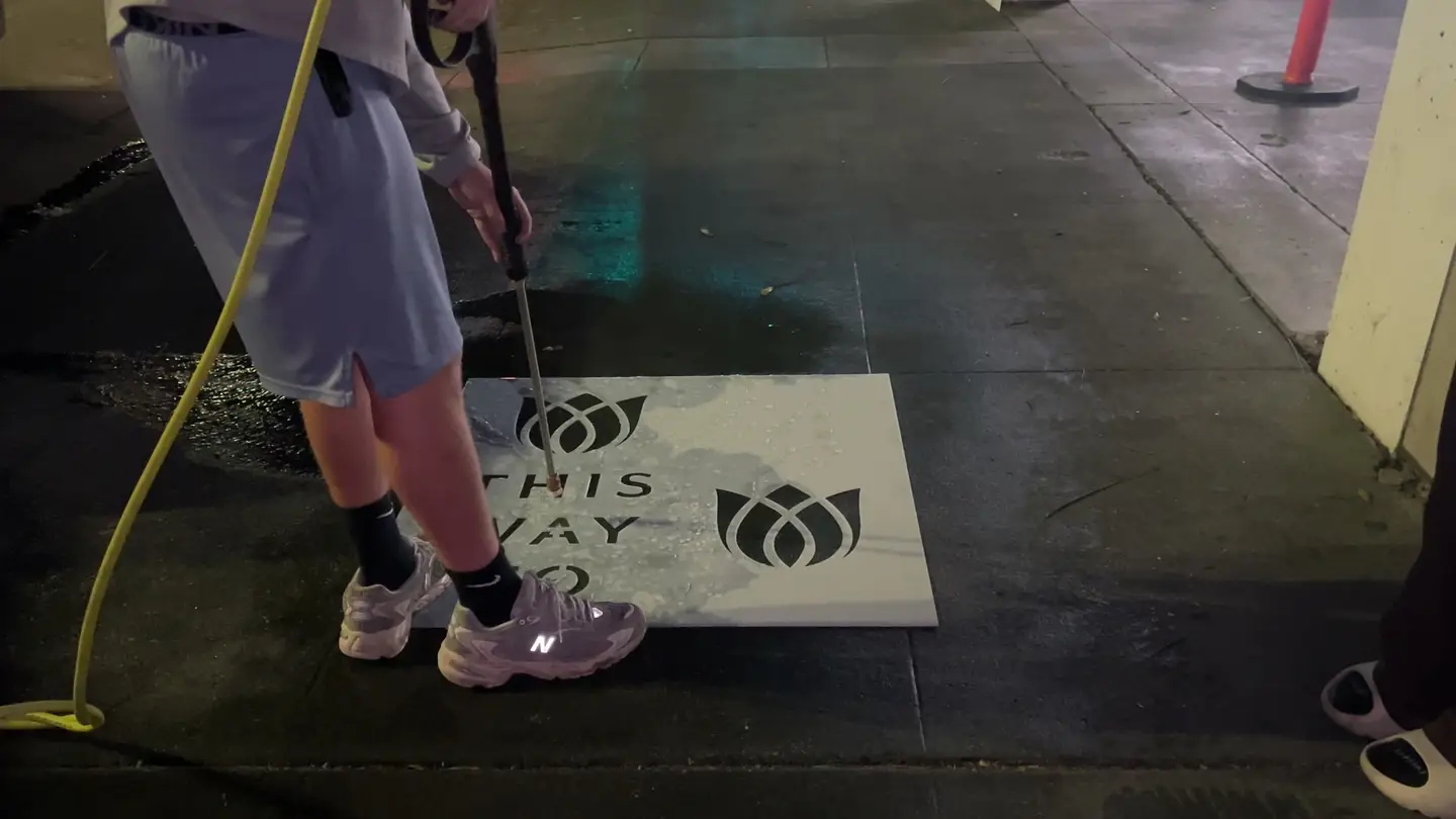 Reverse stencil clean-tag install for Bloomeffects 'Tulip Powered Skincare' on New York City sidewalk in New York City: pressure-washed logo revealed in clean concrete by Beyond Street Media. No paint, no chalk, no ink, only the absence of grime (photo 1 of 4).