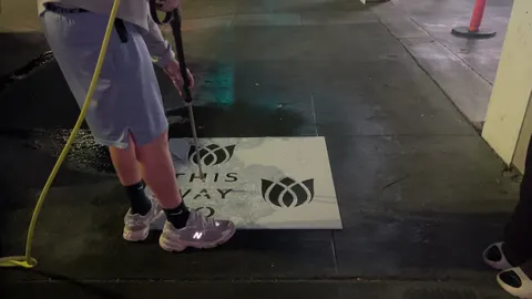 Reverse stencil clean-tag install for Bloomeffects 'Tulip Powered Skincare' on New York City sidewalk in New York City: pressure-washed logo revealed in clean concrete by Beyond Street Media. No paint, no chalk, no ink, only the absence of grime (photo 1 of 4).