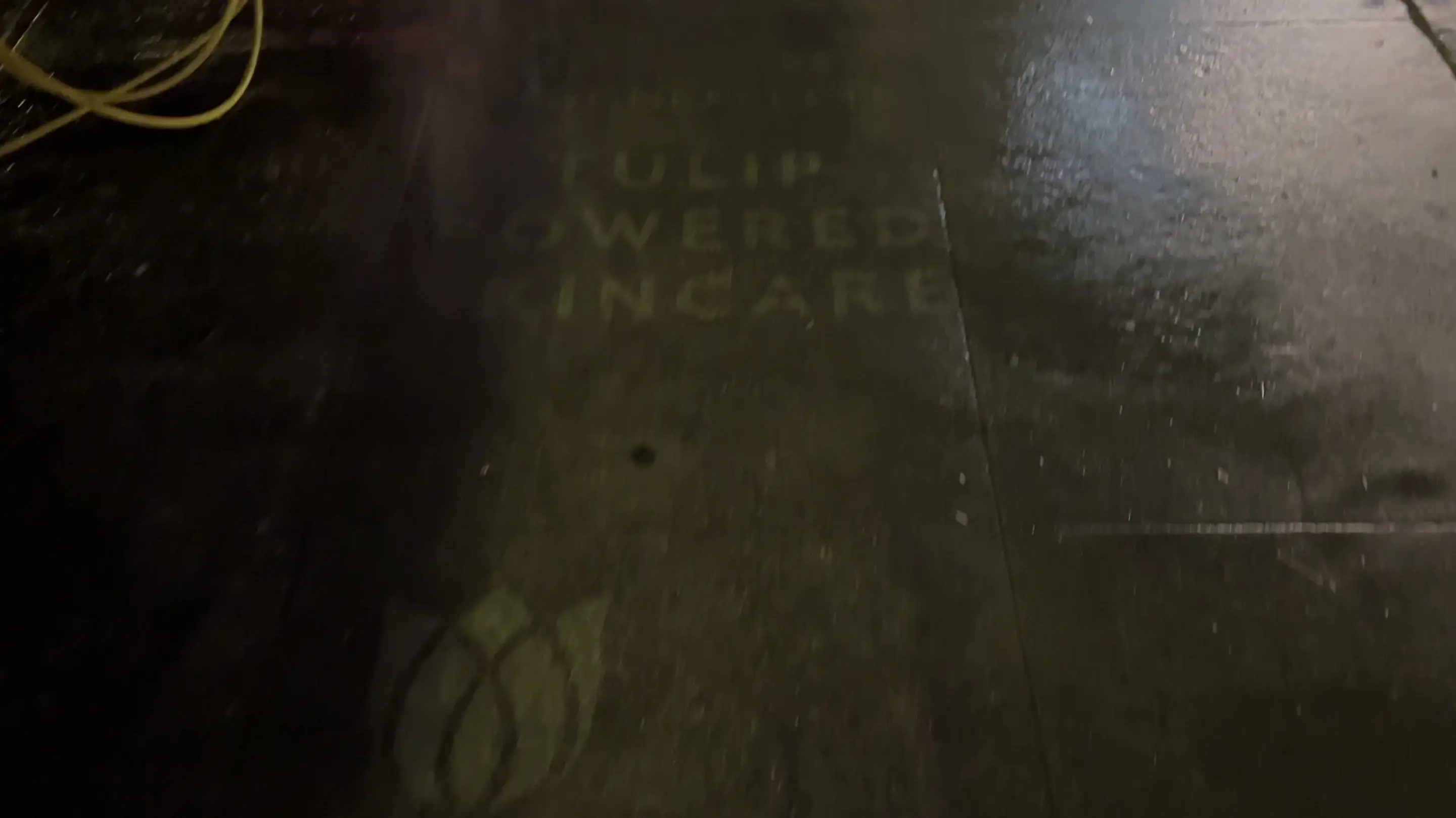 Reverse stencil clean-tag install for Bloomeffects 'Tulip Powered Skincare' on New York City sidewalk in New York City: pressure-washed logo revealed in clean concrete by Beyond Street Media. No paint, no chalk, no ink, only the absence of grime.