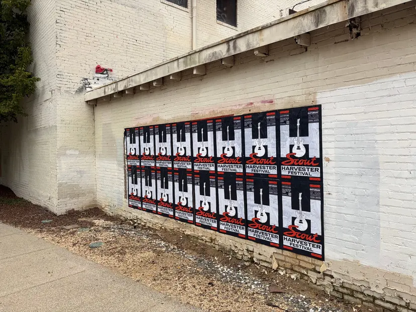 Scout Harvester wheatpaste in the dark colorway on a chipped white brick wall at Charlotte Rail Trail, South End, sixteen sheets