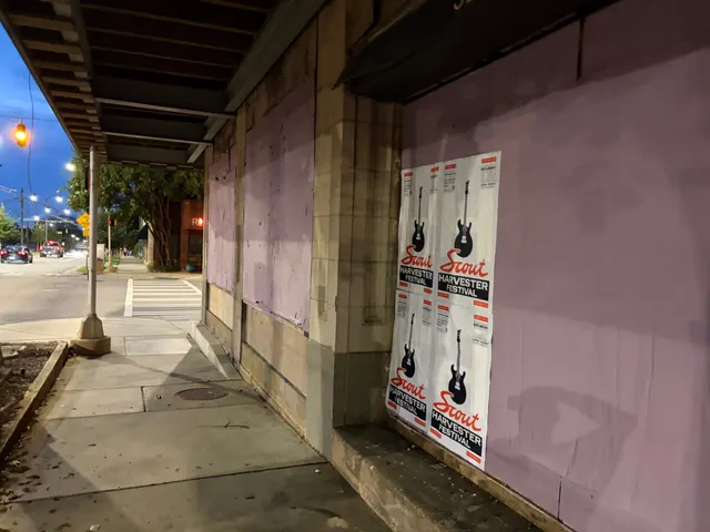 Scout Harvester wheatpaste in the white and silver colorway under an overpass at West Trade Street, Gateway, a red signal at night